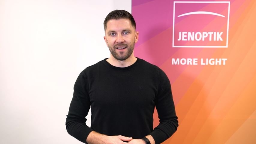 Employee in front of a banner