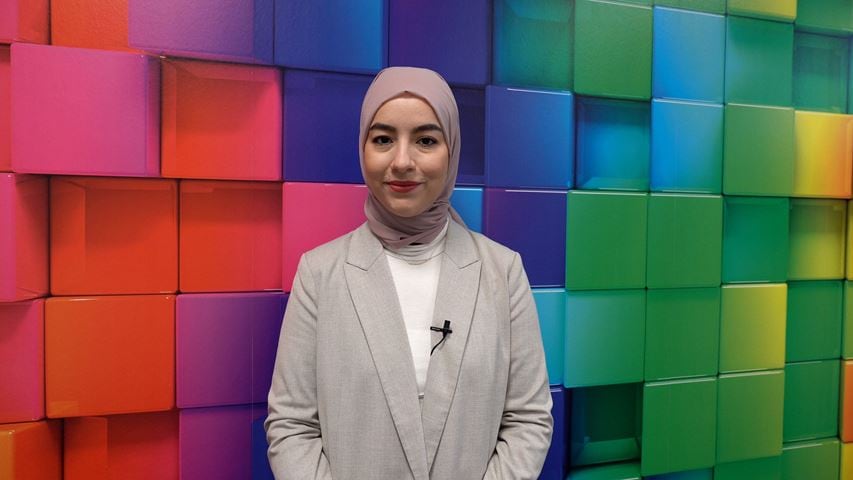 Woman standing in front of poster