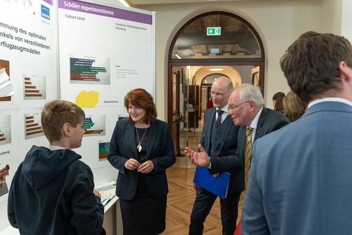 Visitors examine a project booth