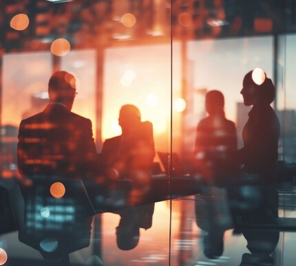 Indistinct group of people in a room with backlighting