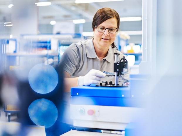 A woman working at a TRIOPTICS metrology station
